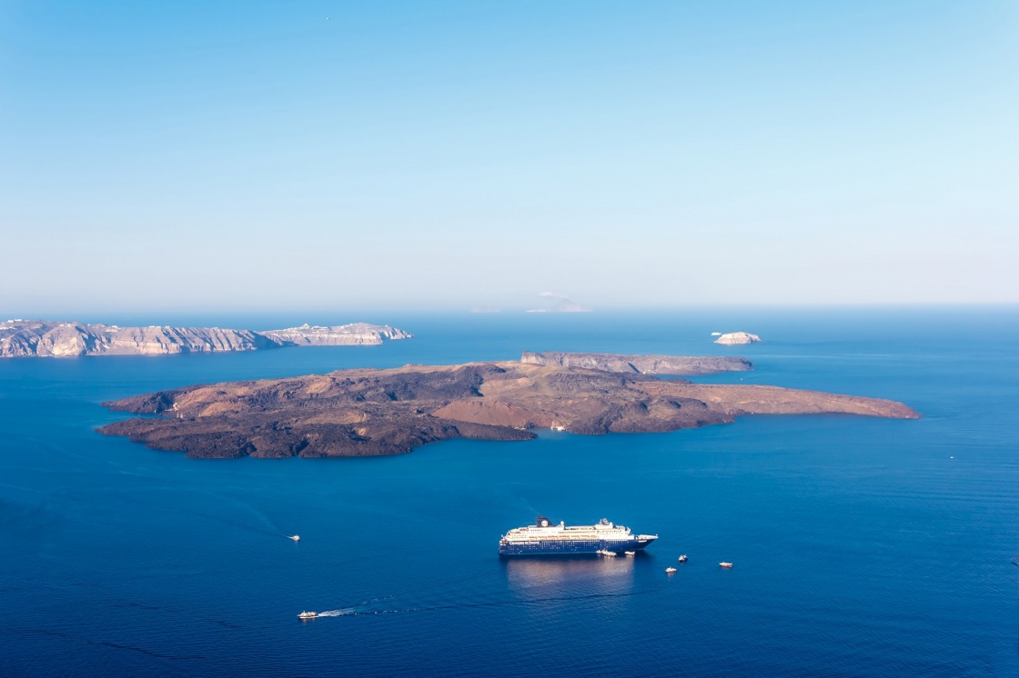 'Nea Kameni volcanic island in Santorini Greece with ships in front photographed from a high point of view' - Σαντορίνη
